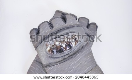 Abstract defocused photo of motorcycle riding gloves isolated on white background