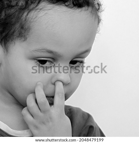 boy picking his nose on white background stock photo  