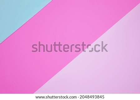 Abstract background from pink and blue color paper. Paper background with diagonal lines. Sheets of paper of different colors. 