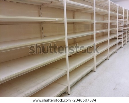 Food shortage, empty supermarket shelves, stalls without items, economic crisis, out of stock.