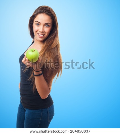 portrait of a young woman holding a green apple