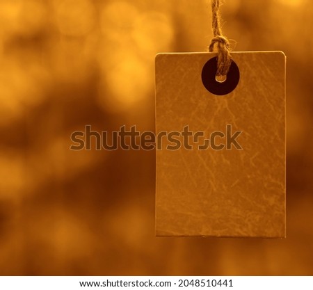 yellow square price tag against the background of fallen autumn foliage. Label for fall sale on trees background. Autumn promotion banner design.