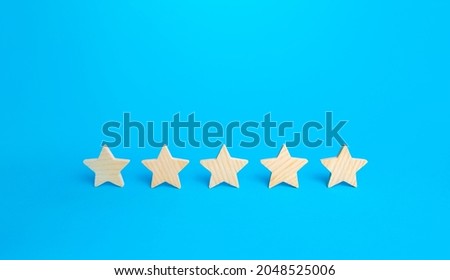 Five stars on a blue background. Rating evaluation concept. High satisfaction. Good reputation. Popularity rating of restaurants, hotels or mobile applications. Highest score. Service quality feedback Royalty-Free Stock Photo #2048525006