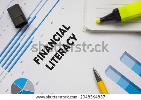 Business concept meaning FINANCIAL LITERACY with sign on the piece of paper. 
