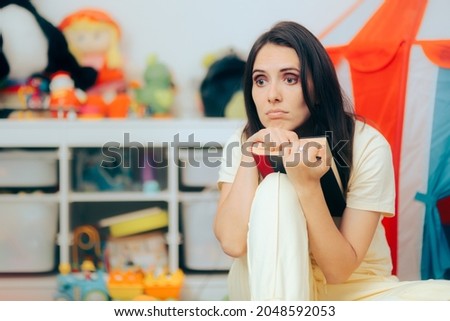 Sad Depressed Mom Holding a Book Sitting on the Floor. Unhappy woman reading feeling bored and anxious
 Royalty-Free Stock Photo #2048592053