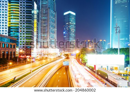 the light trails on the modern building background in shanghai china. 