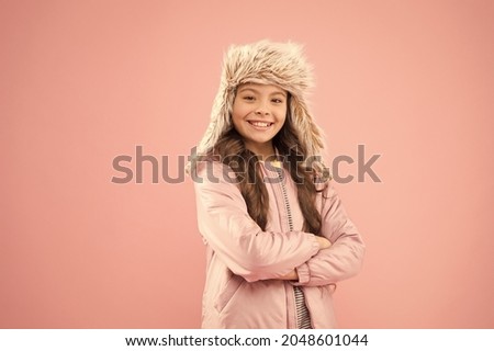 Cute smiling model. Adorable small child wear winter knitted accessory. Cute little girl fashion hat pink background. Clothes shop. Hats for winter season. Winter outfit. Shopping for accessories