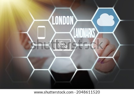 Sign displaying London Landmarks. Word Written on most iconic landmarks and mustsee London attractions Lady Holding Tablet Pressing On Virtual Button Showing Futuristic Tech.