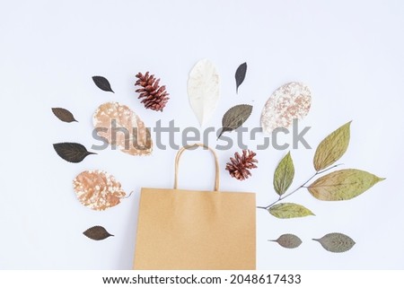 Minimalist Autumn Concept. Dried Leaves, Pine Flowers, Paper Bags Isolated On White Paper Background
