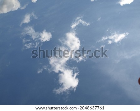 White clouds in the blue sky can be used as a background.