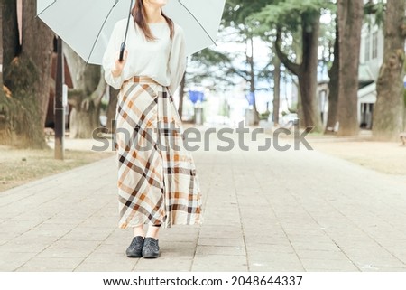 A person who meets
A woman with an umbrella Royalty-Free Stock Photo #2048644337
