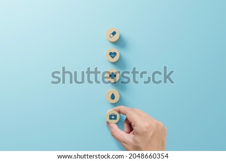 Hand arranging wood block with icon healthcare medical, Insurance for your health concept Royalty-Free Stock Photo #2048660354