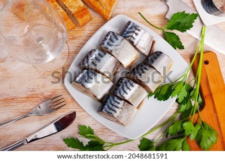 Picture of tasty slices of lightly salted mackerel with greens at plate
