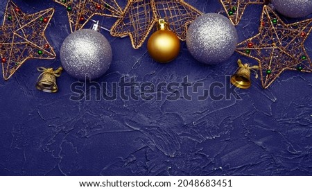 Beautiful christmas golden silver deco baubles on dark black background. Flat lay design.