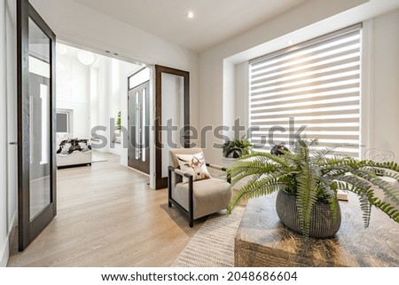 Home office with glass french doors desk globe clock and large windows with blinds Royalty-Free Stock Photo #2048686604