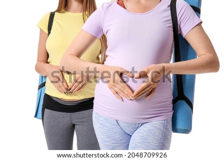 Young pregnant women with yoga mats on white background, closeup