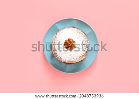 Tasty donut for Hanukkah on color background Royalty-Free Stock Photo #2048753936