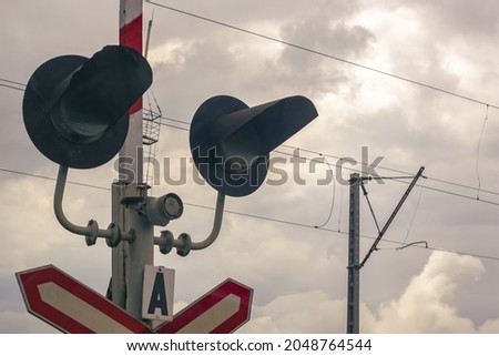 Traffic light at a railway crossing. The object of increased attention is at the intersection of the road and railways.