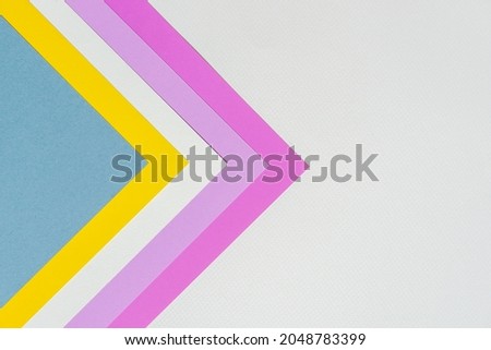 abstract background concept with stacking of color paper in geometric pattern, layers of blank pink paper, purple , white, yellow and blue on white paper background.