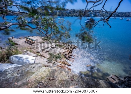 beautiful turquoise and blue waters of Beauty Point  Mosman on a Spring morning with yachts and houses in background NSW Australia