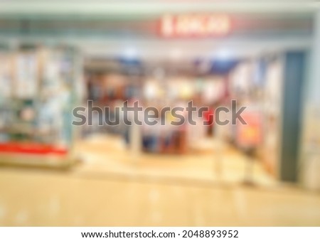 Defocused abstract background of fashion clothes store in shopping mall or shopping center. Bokeh Store front image for background. 
