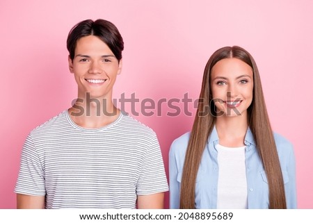 Photo of charming pretty young couple wear casual clothes smiling isolated pink color background
