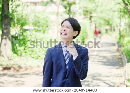 Asian businessman walking outdoor in the summer Royalty-Free Stock Photo #2048914400