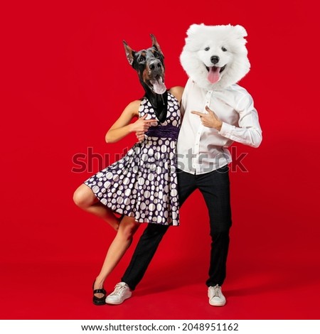 Retro dances. Young man and woman headed with dog's heads dancing isolated over red background. Modern design, contemporary art collage. Inspiration, idea, magazine style. Surrealism, ad