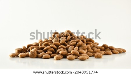 Pile of dry food kibbles for pets. Front view. Horizontal composition. Royalty-Free Stock Photo #2048951774