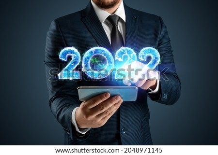 Blue hologram number 2022 on the background of a businessman. Happy New Year. Modern design, Template, header for the site, poster, New Year's card, flyer