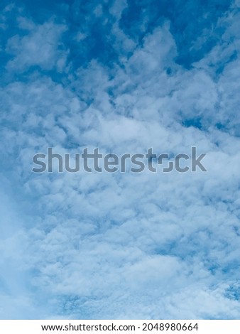 The white Altocumulus cloud has spherical, partially dispersed fibers. Where the clouds will clump together to float in a raft parts of the clouds may allow some light to pass through. no focus