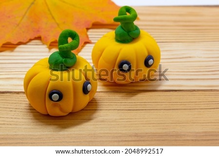 Halloween party background, Fondant paste figure pumpkin on wooden rustic background, copy space, card, invitation, cupcakes topper halloween Royalty-Free Stock Photo #2048992517