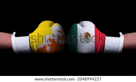 Two hands of wearing boxing gloves with Mexico and Bhutan flag. Boxing competition concept. Confrontation between two countries