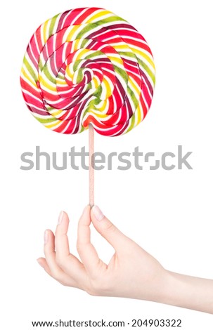 Bright colorful lollipop with hand over white background isolated