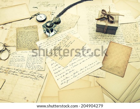 old letters, vintage postcards and antique feather pen. nostalgic sentimental background. retro style toned picture