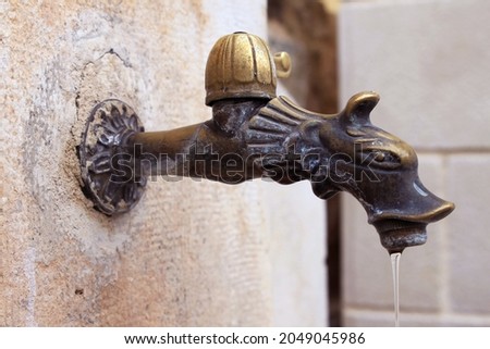 Beautiful old elaborately decorated old vintage brass tap Royalty-Free Stock Photo #2049045986