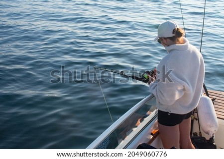 Female Fisherman with fishing rod on a boat in the ocean near Stavanger Norway (jig fishing) Royalty-Free Stock Photo #2049060776