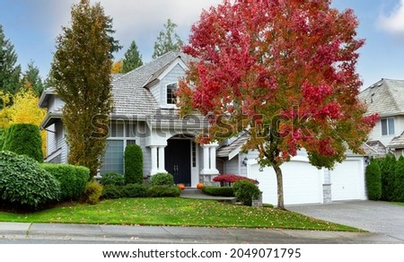 Suburban modern home during early autumn as leaves turn yellow and red 