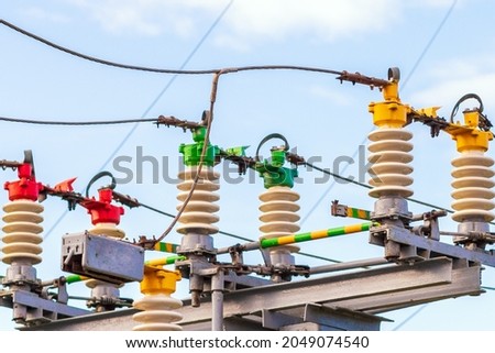High voltage circuit electric breaker in a power substation.Closeup of high voltage insulators at new substation.Storage outdoors current transformer. Royalty-Free Stock Photo #2049074540