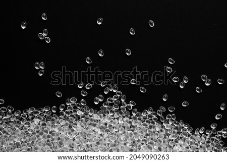 White granules of rubber, polypropylene or polyamide on a black background. Royalty-Free Stock Photo #2049090263