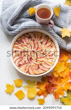 Apple pie layout and autumn leaves top view . An article about autumn. An article about baking. Homemade cakes. Autumn picture