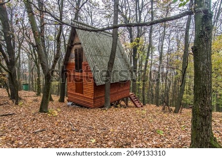 Lonely wooden house in the autumn forest