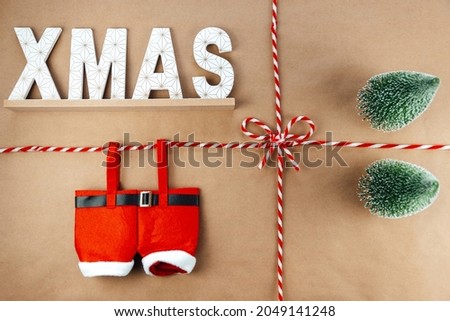 Christmas string or twine tied in a bow on kraft paper backdrop with xmas sign and Santa Claus