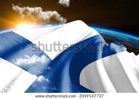 Finland national flag cloth fabric waving on beautiful sky.