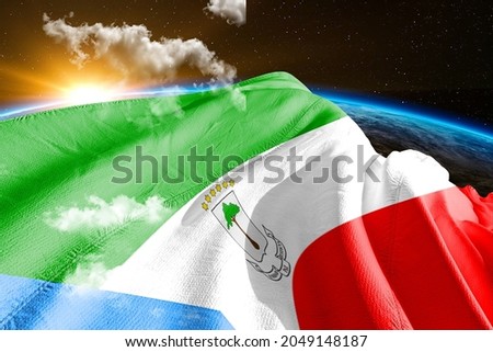 Equatorial Guinea national flag cloth fabric waving on beautiful sky.