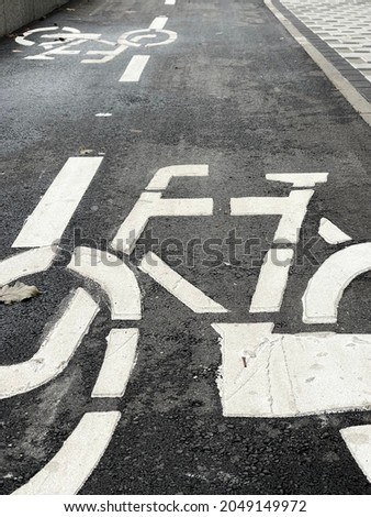 Cropped close up of bicycle sign painted on cycle lane
