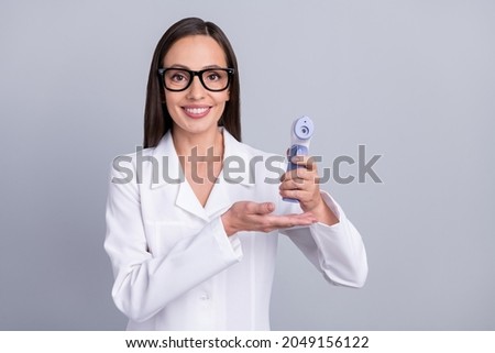 Photo of mature woman happy positive smile show advertise thermometer health care isolated over grey color background