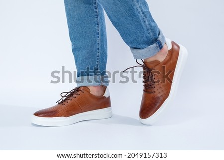 Men's casual shoes are brown with natural leather, men on the shoe in brown lace shoes. High quality photo Royalty-Free Stock Photo #2049157313
