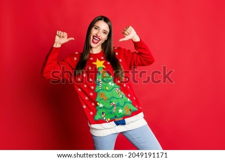 Photo of cheerful happy brunette proud young woman wear jeans point fingers herself xmas isolated on red color background