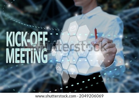 Hand writing sign Kick Off Meeting. Word for first meeting with the project team and the client Lady In Uniform Holding Tablet In Hand Virtually Typing Futuristic Tech. Royalty-Free Stock Photo #2049206069